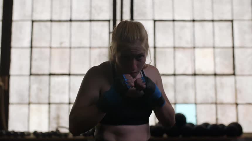 Woman in a gym practicing her boxing stance