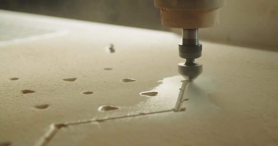 Power tool carving grooves on the surface of a sheet of plywood