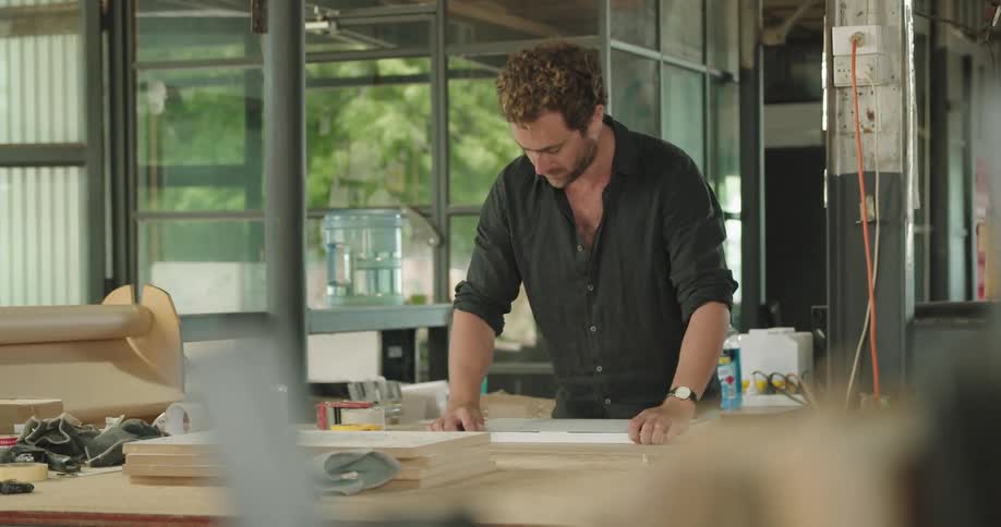 A man taping up a piece of cardboard