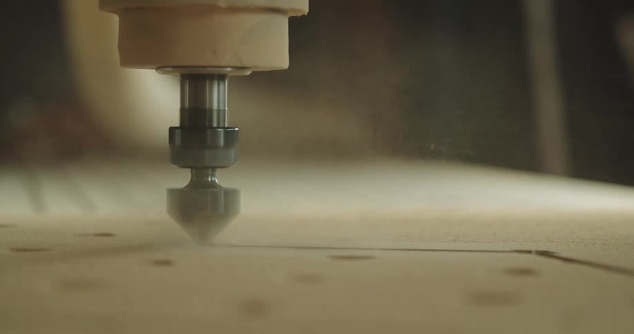 A dremel is used to carve out a zigzag line on a piece of wood