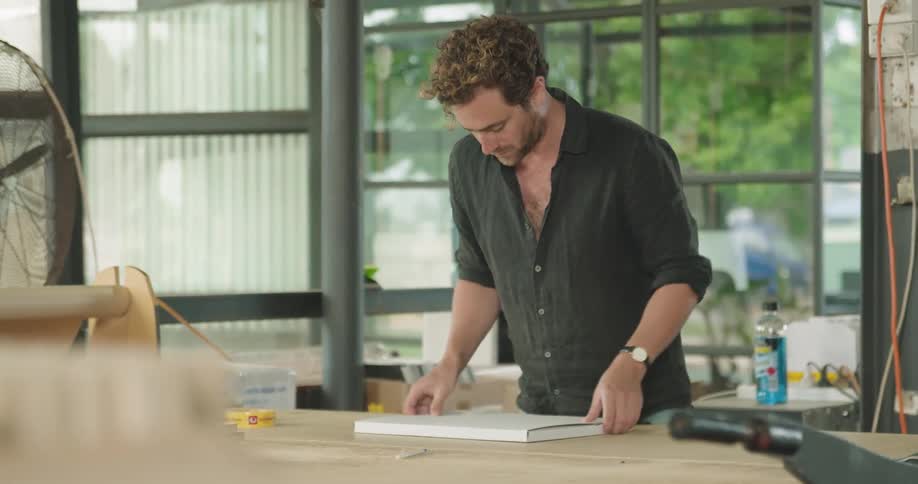 Man working in a workshop in a warehouse packaging a product