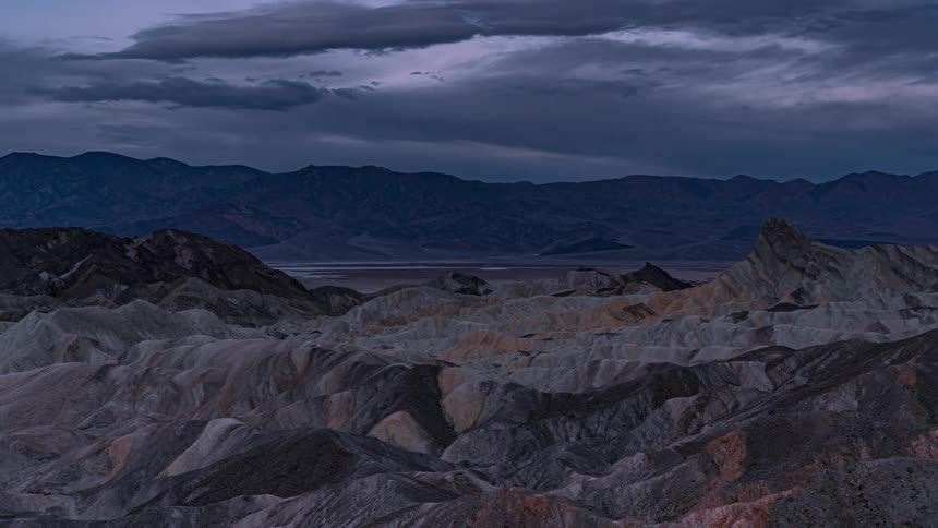 Colorful clouds move over mountains