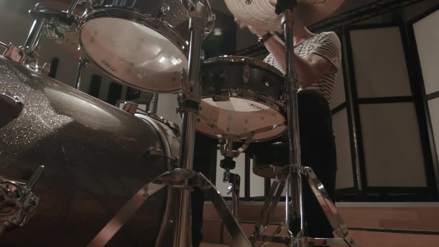 A person playing on a drum set