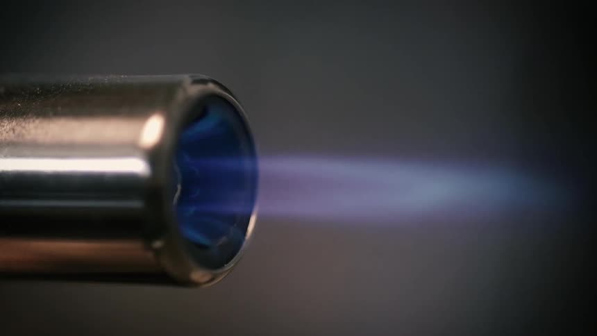 A blue flame at the end of a nozzle