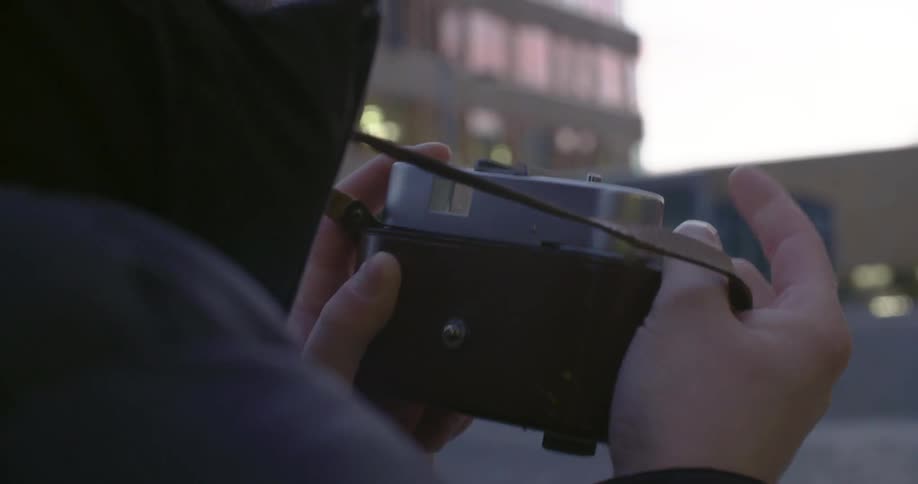 A person moves a lever on a camera