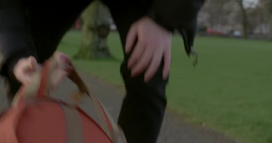 A man places a camera in his backpack then wears the backpack