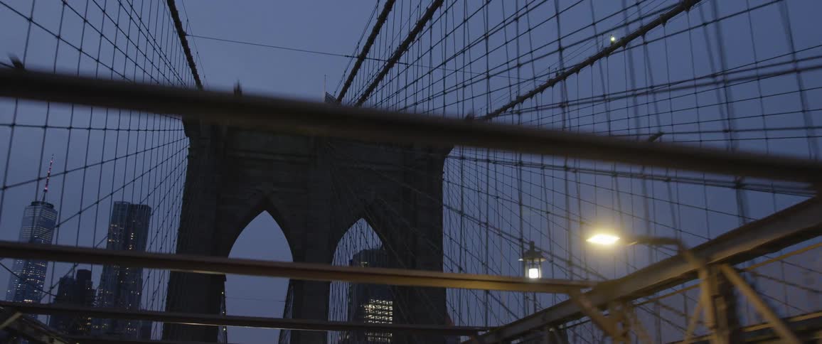 A large city bridge and skyscrapers at night