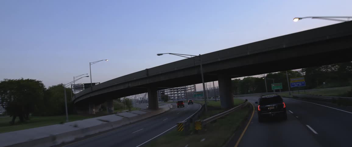 Cars driving on highway under overpass in urban area