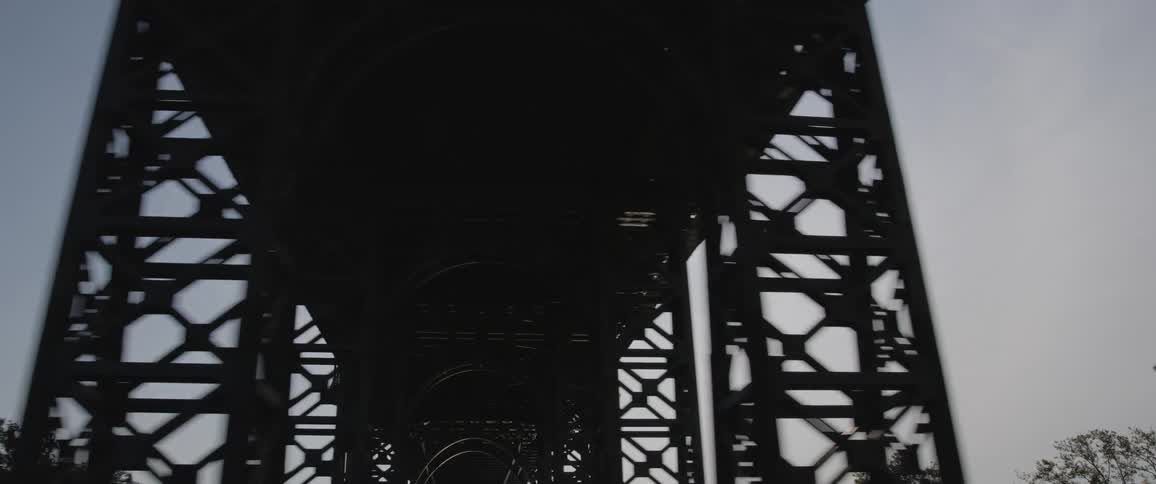 A large city bridge towering overhead on a sunny day