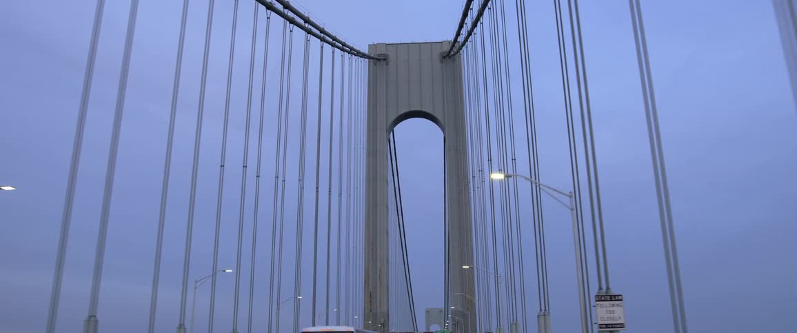 Cars and trucks traveling on a suspension bridge