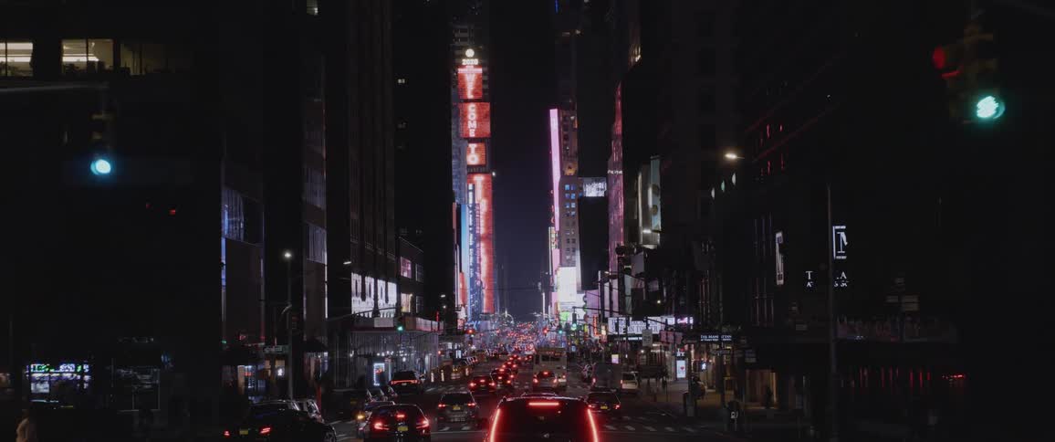 Driving downtown in a metro area at night with lots of traffic
