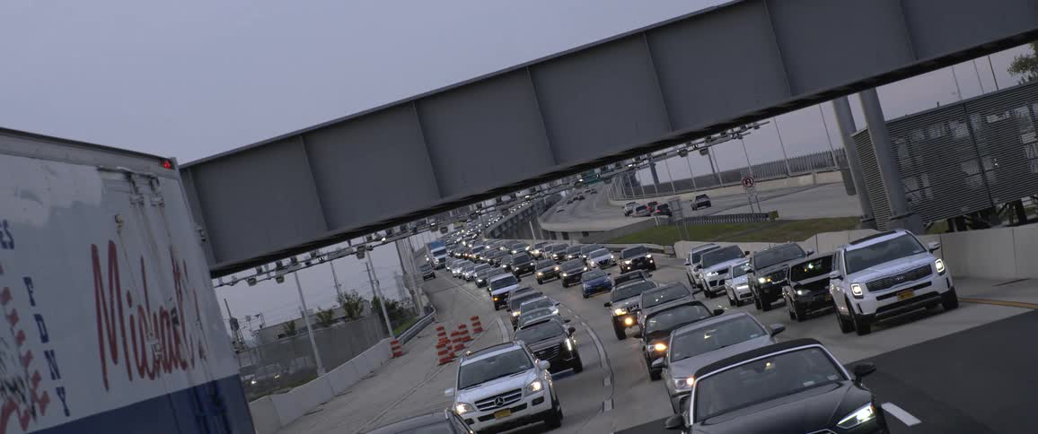 Heavy traffic congestion slowly moves down a curving freeway