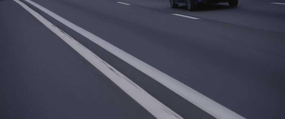 Cars are driving on a road during the day