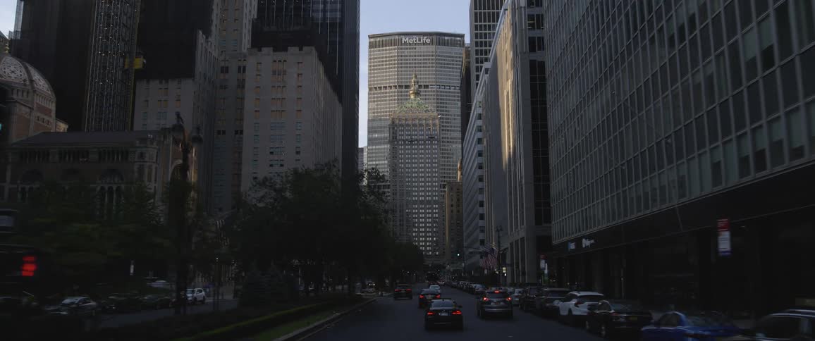 Cars are driving through a downtown city