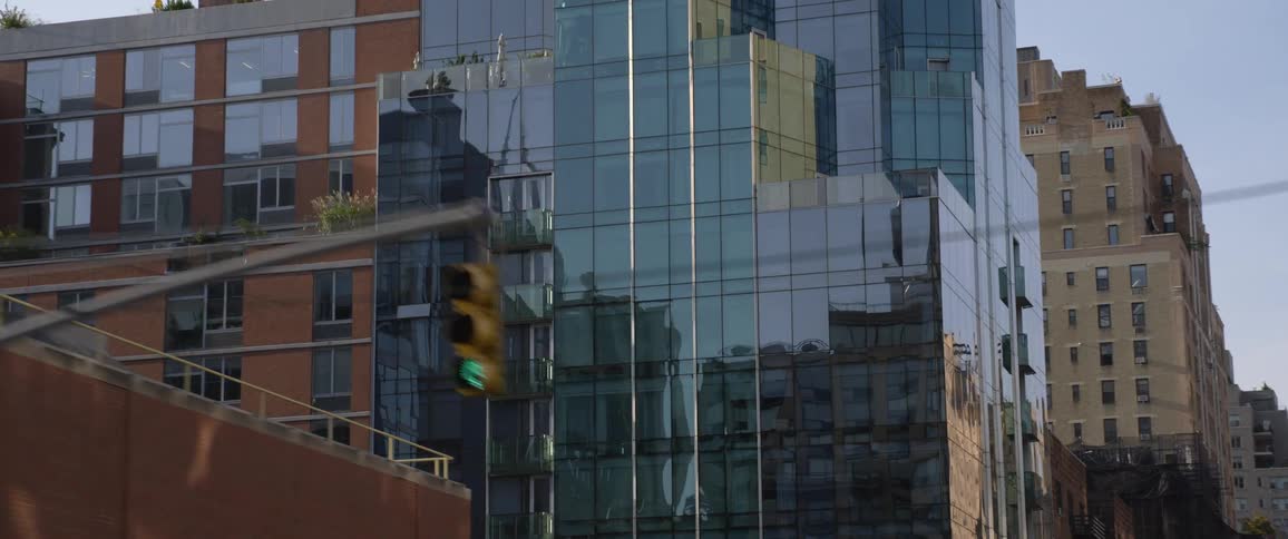 A tall glass skyscraper in a city