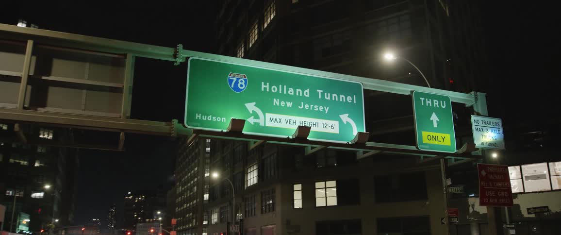 Holland tunnel exit sign in a metro area