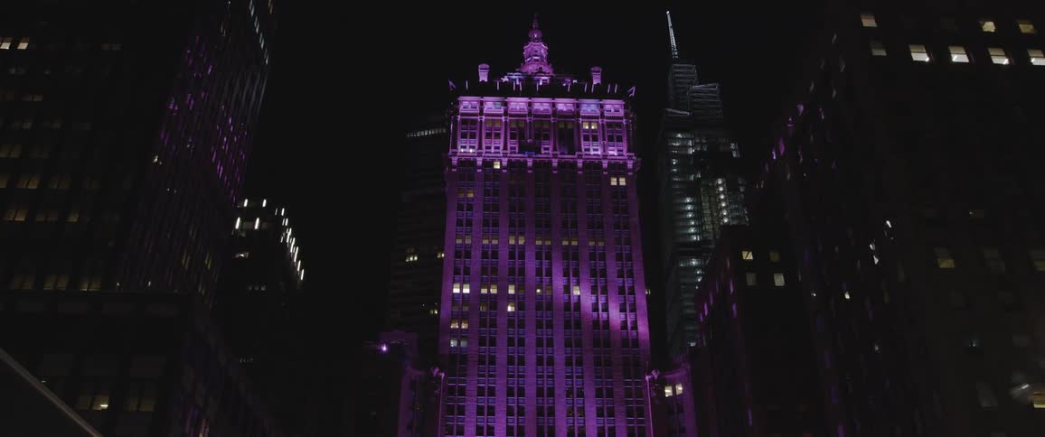 A moving shot of a building lit to be purple