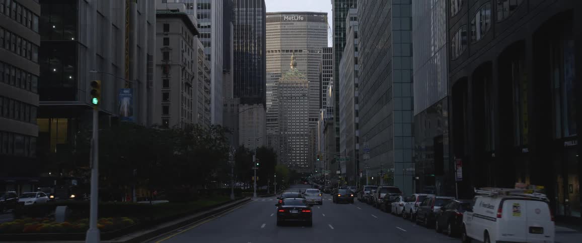 A street downtown with traffic and buildings all around