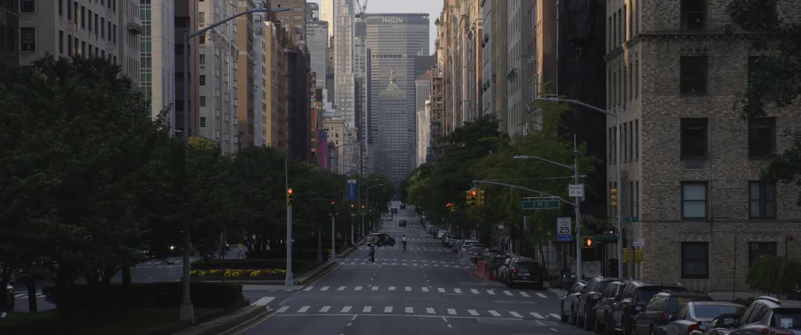 Cars are driving in a downtown city during the day