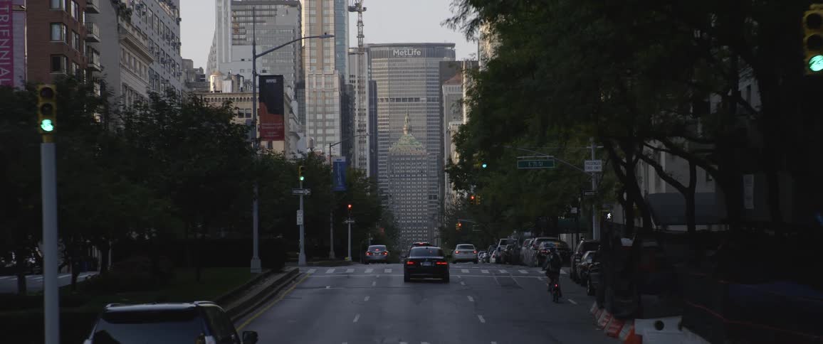 Cars driving on a road in the citys downtown at morning