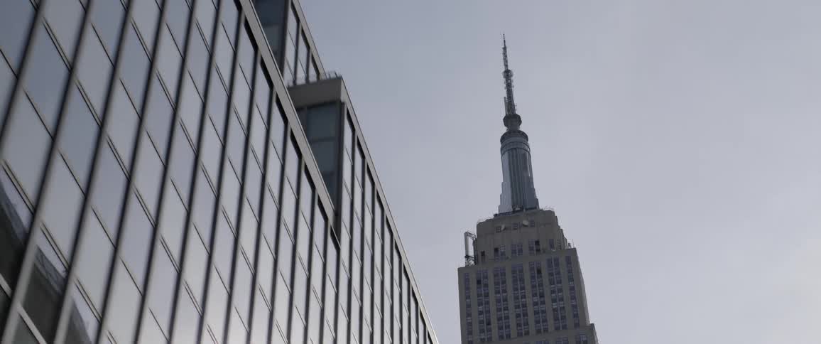 The spire of the empire state building in new york city at evening
