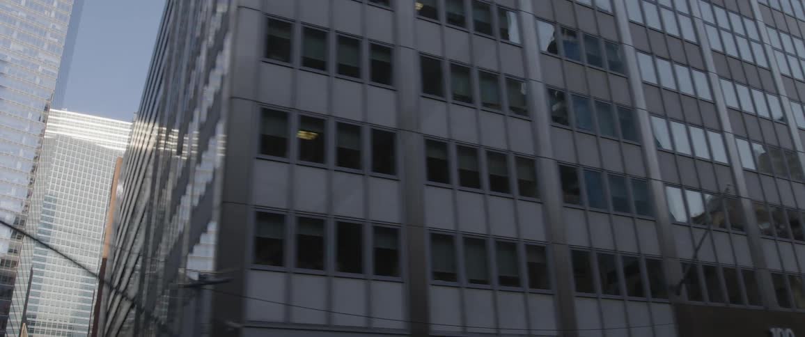 Large office buildings along a road in a metropolis on a sunny day