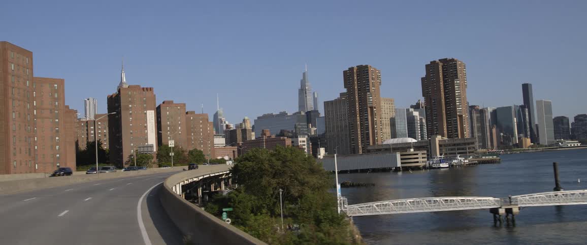 Skyline of a coastal city downtown filmed from a moving car in the highway