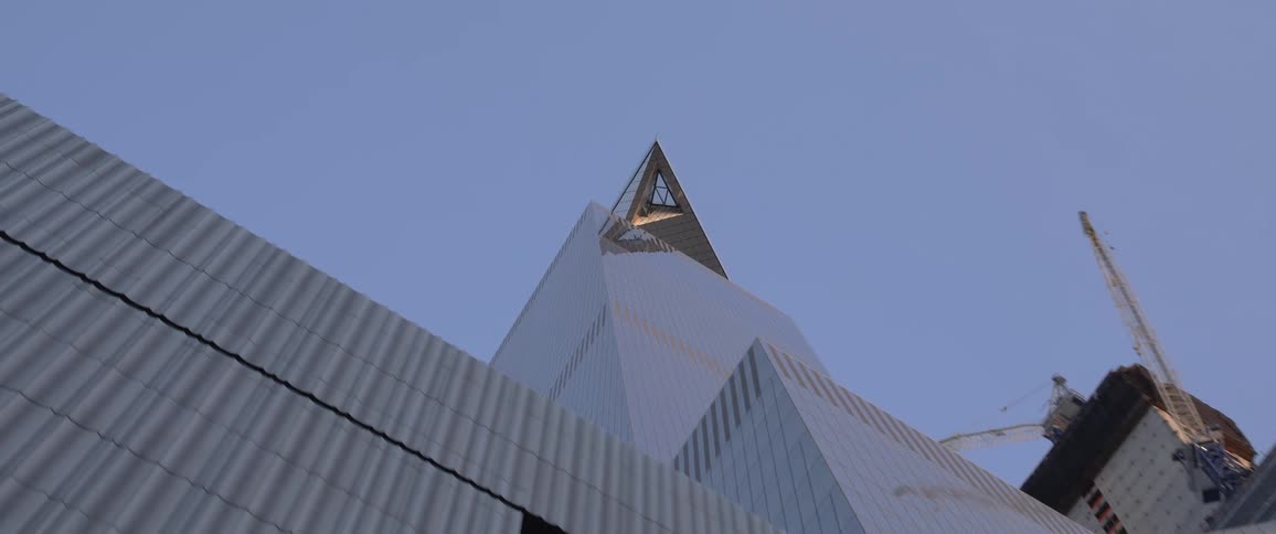A construction crane on a high rise office building