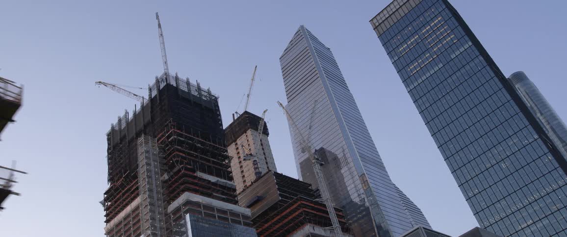 Tall skyscrapers tower over other buildings in an urban area