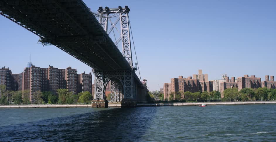 Moving under a large bridge leading to a city
