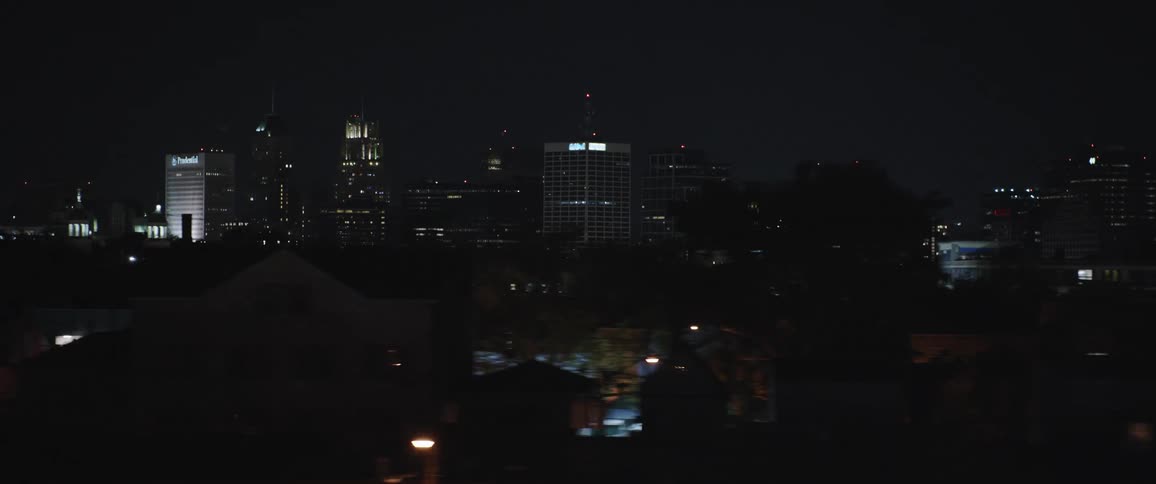 Big city skyline with distant illuminated buildings at night