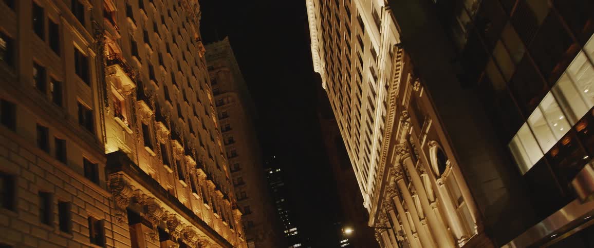 Light shines from building windows in downtown at night