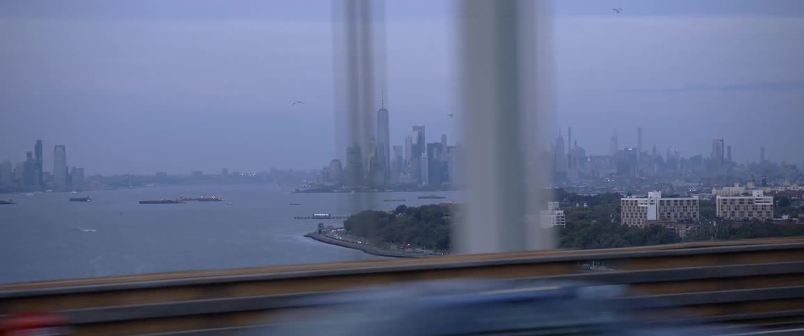 Boats on the water with the city skyline in the distance