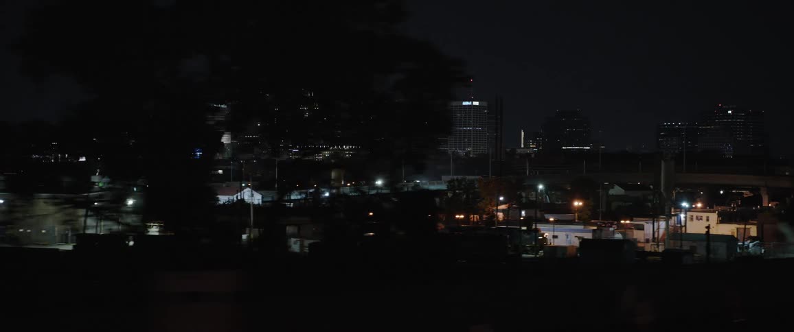 A factory with the city skyline in the distance