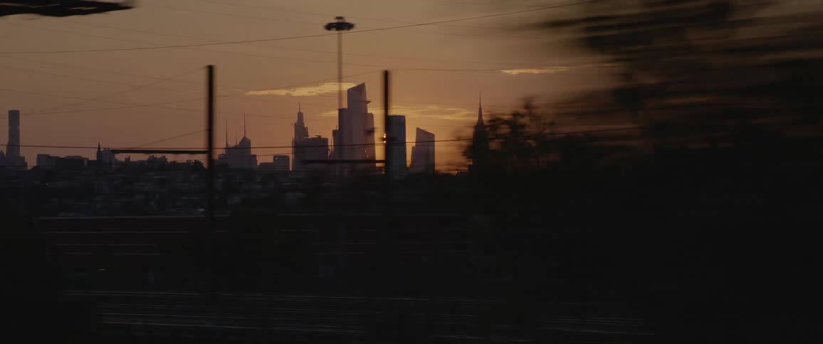 The sun setting behind buildings in a city skyline