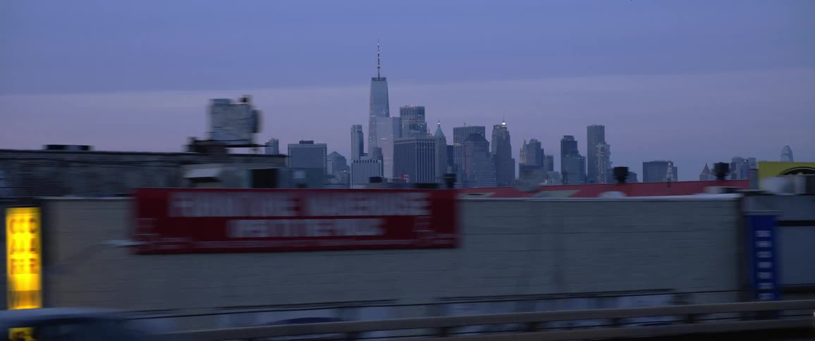 Highway with traffic against a skyline with other buildings