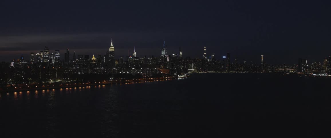 City lights shimmer and glow at night along the waterfront
