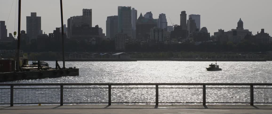 City skyline with a body of water with a boat