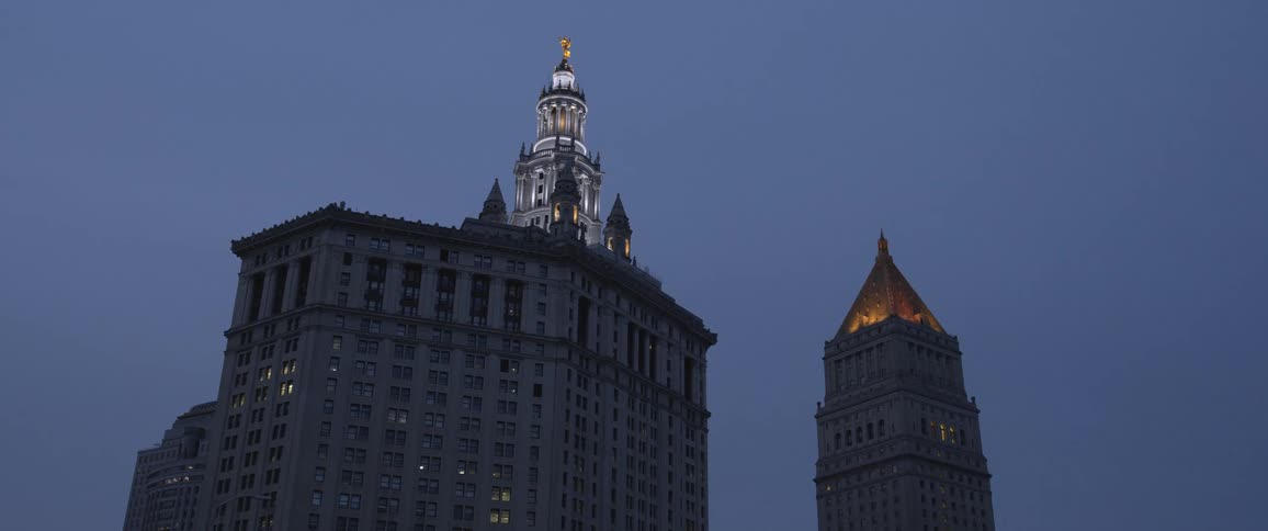 Tall towers and buildings on the city skyline at evening