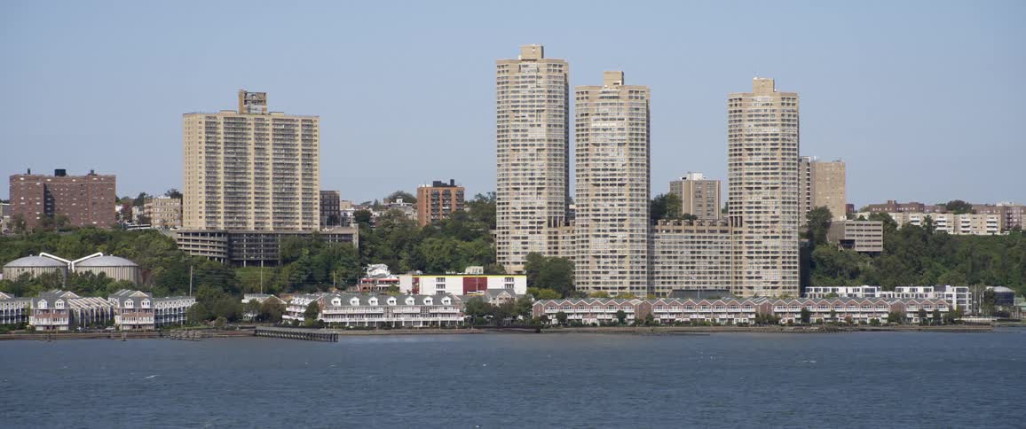 A landscape view of the water with office buildings on the shore