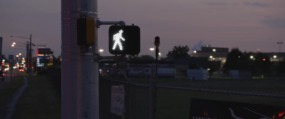 A close up of a sidewalk crossing sign