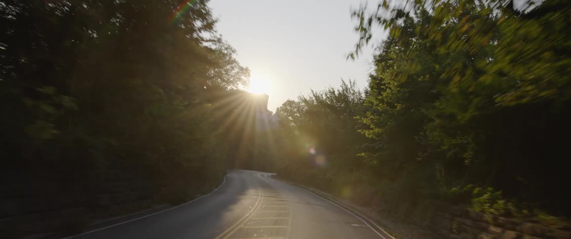 A car driving down a rural highway