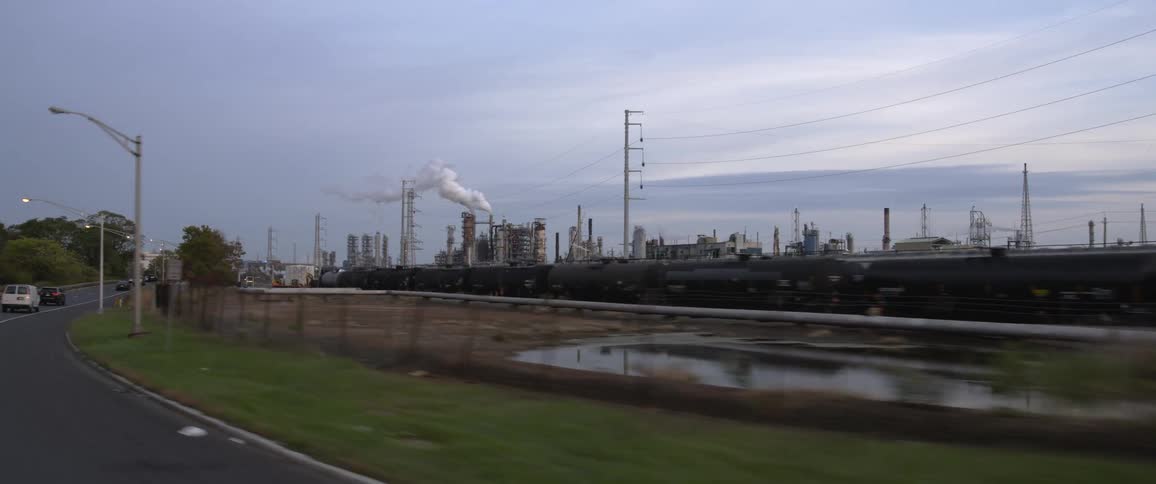 Industrial complex in the horizon near the road at morning