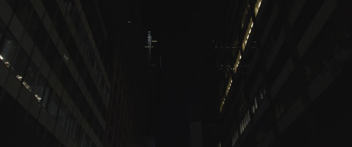 The gap between densely packed buildings in a metropolis at night