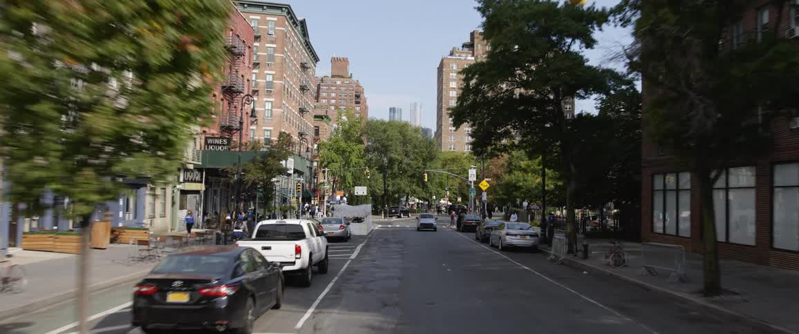 Vehicles travel on a road in the city