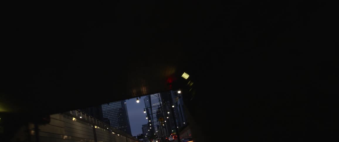 A road leading through a tunnel in a metropolis in the late evening