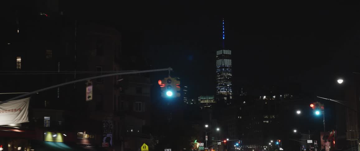 Night time of dense urban environment with large skyscraper