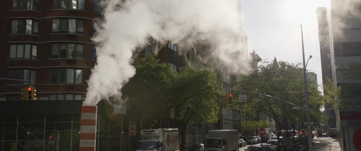 Smoke rising from a construction site on a city street