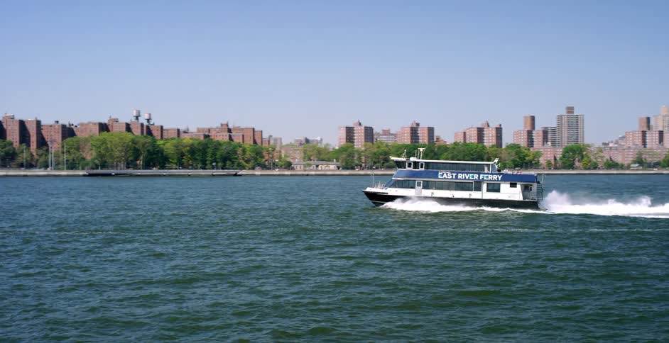 A ferry is moving fast across the water