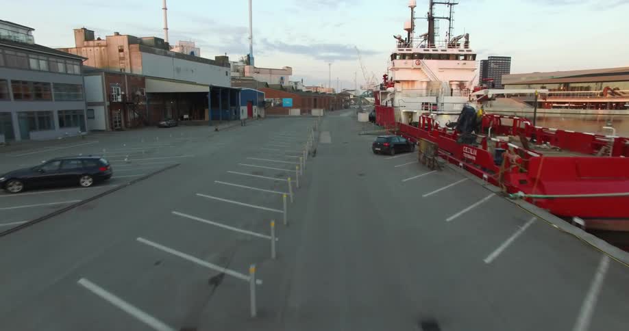 A person running down a parking lot near a body of water